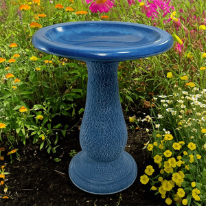 Navy Blue Fiber Clay Bird Bath in a garden setting, featuring a 19-inch diameter basin, ideal for attracting birds. Lightweight and easy to move.