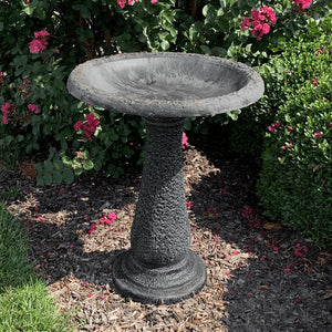 Sand Fiber Clay Bird Bath in a garden, featuring a full-sized basin for birds to play and splash. Lightweight and easy to move.