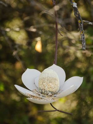 Single Magnolia Bird Feeder with showy petals and rust-colored branch, offering a sheltered feeding area. Suitable for year-round outdoor use, includes hanging cable.