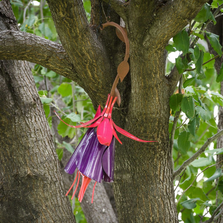 Fuchsia Hummingbird Feeder, crafted from plastic bags, features a flower design with long trailing pistils and includes an 8 oz. nectar bottle and hanging chain.