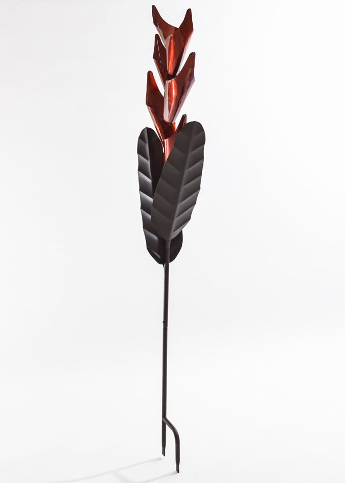 Heliconia Bird Feeder featuring a metal flower design on a stick, with cascading bird seed through red petals, offering durable, all-metal construction.