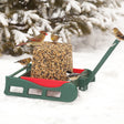 Duncraft Sleigh Seed Block Feeder with birds perched on a handcrafted sleigh-shaped feeder, designed for winter feeding with multiple perches and durable recycled plastic.