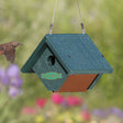 Duncraft Wren Bird House with a bird flying near it, featuring a wedge-shaped design, built-in ventilation, and a 1-1/8 inch entry hole.