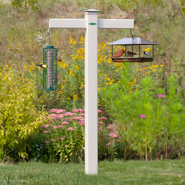 Duncraft Masterpiece 84 Feeding Station with birds on two-arm feeder, showing durable PVC post and carabiners for easy feeder attachment.