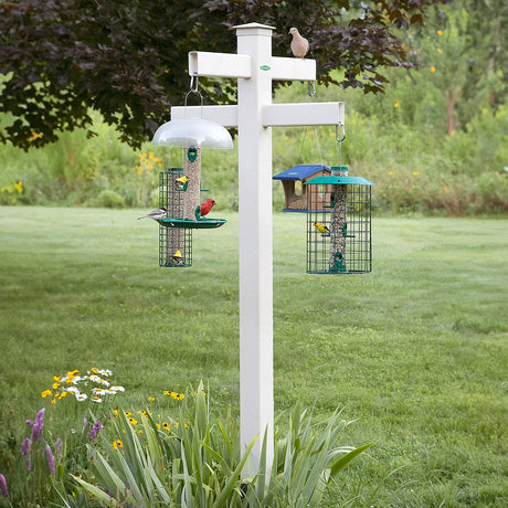 Duncraft Masterpiece 84 Quad Station with four arms for bird feeders, shown in an outdoor garden setting with birds feeding. Durable, easy to maintain.