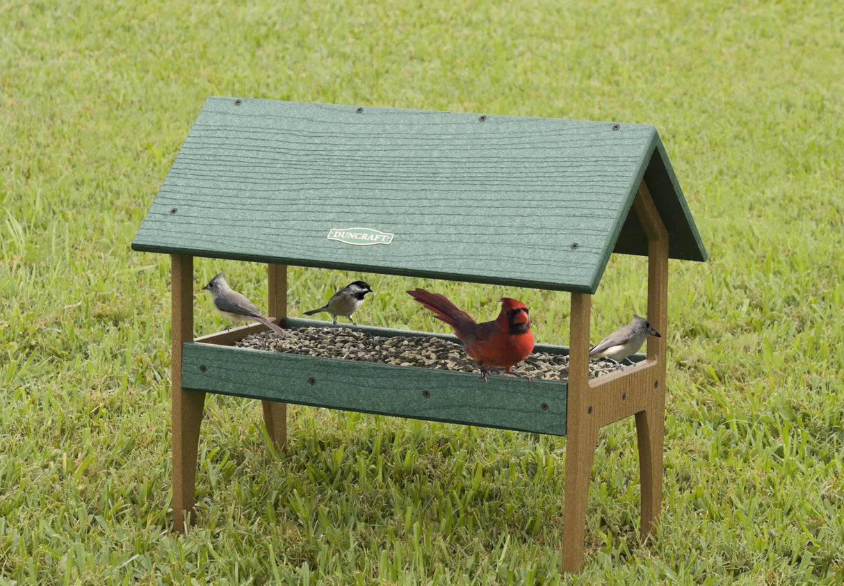 Duncraft Eco-Strong Ground Tray Platform Feeder with birds feeding, featuring fly-through openings, built-in perching space, and metal mesh flooring for drainage.