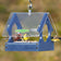 Duncraft Songbird Mealworm Magnet Feeder with birds feeding through fly-through openings, featuring a clear plastic roof and metal mesh flooring.