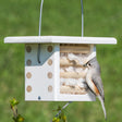 Duncraft Bird's Nest Builder showing a bird perched on a feeder, featuring wooden dowels and a metal wire hanger, with 100% cotton nesting material.