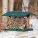 Duncraft 4-Sided Classic Hopper Feeder with three songbirds feeding, featuring a 5 lb. capacity and wide openings against a wintry backdrop.