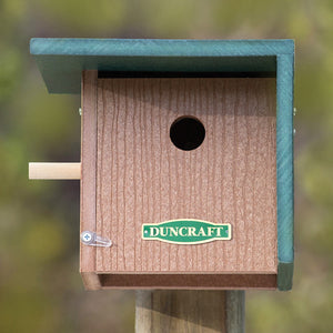 Duncraft Wind Block Wren House mounted on a post with a 1-1/2 inch entry hole and wind block panel, featuring a wooden lookout perch.