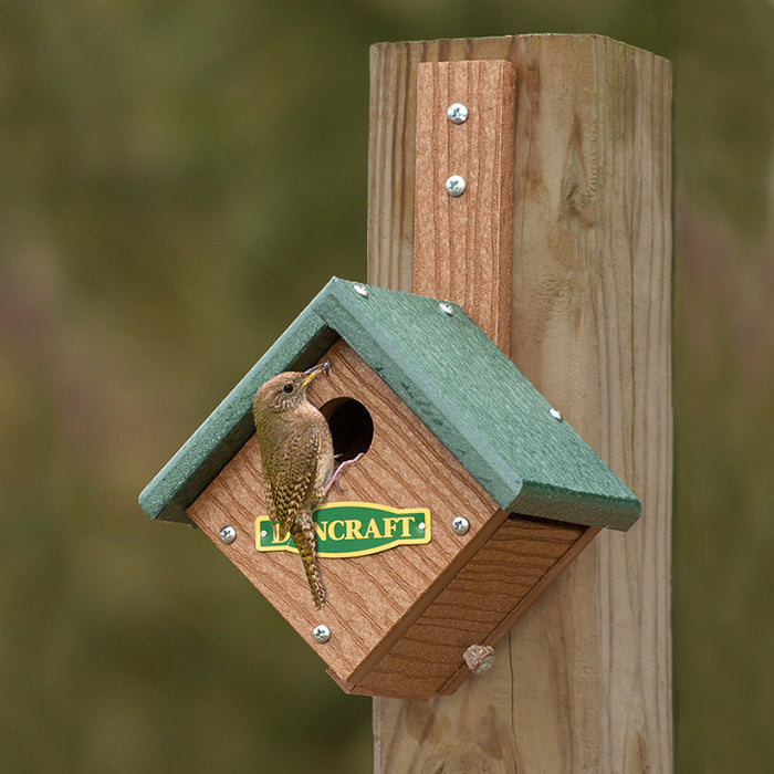 Duncraft EZ Mount Wren Diamond House featuring a bird perched on a wooden birdhouse, designed for small birds with a 1-inch entry hole.