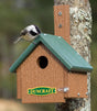 Duncraft EZ Mount Chickadee Cape House with a chickadee perched at the entrance, showcasing a small, durable birdhouse designed for safe nesting.