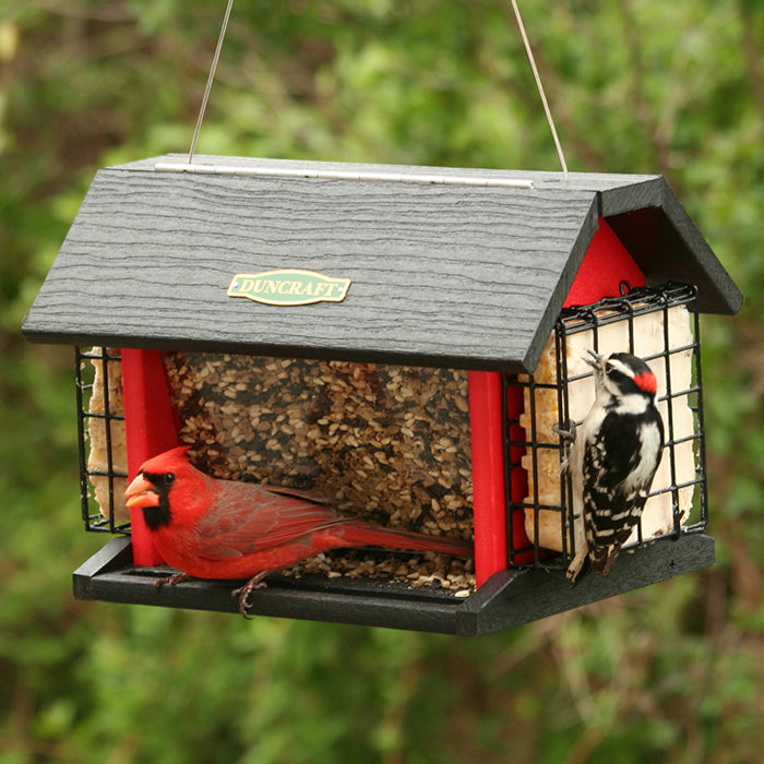 Red Barn Cardinal Feeder with a red bird perched on a side, designed for year-round feeding from all four sides, includes a cable hanger and two seed trays.