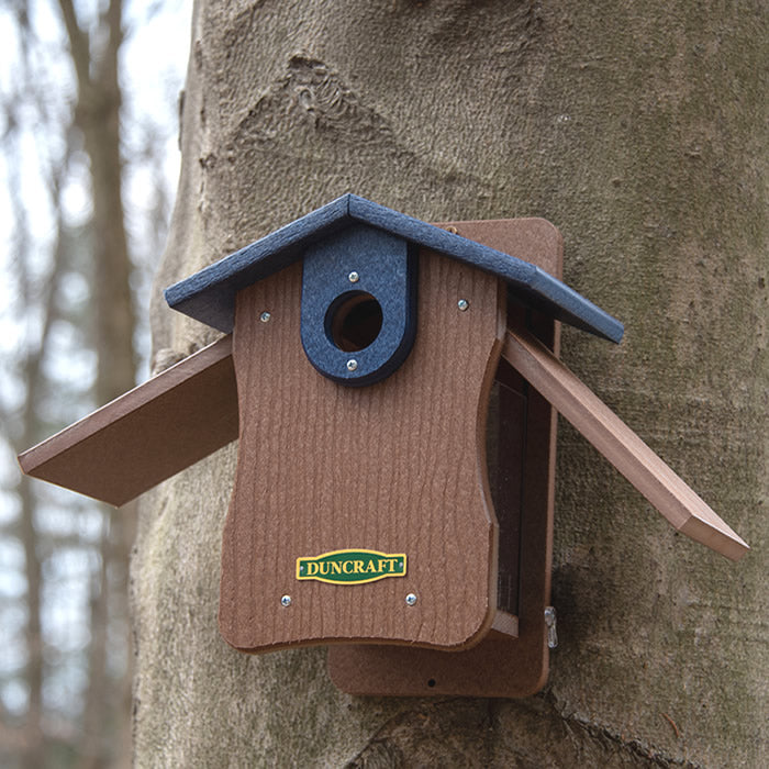 Duncraft Bird-Safe® EZ Observation Bluebird House with Predator Guard mounted on a tree, featuring side panels for observation and easy cleanout.