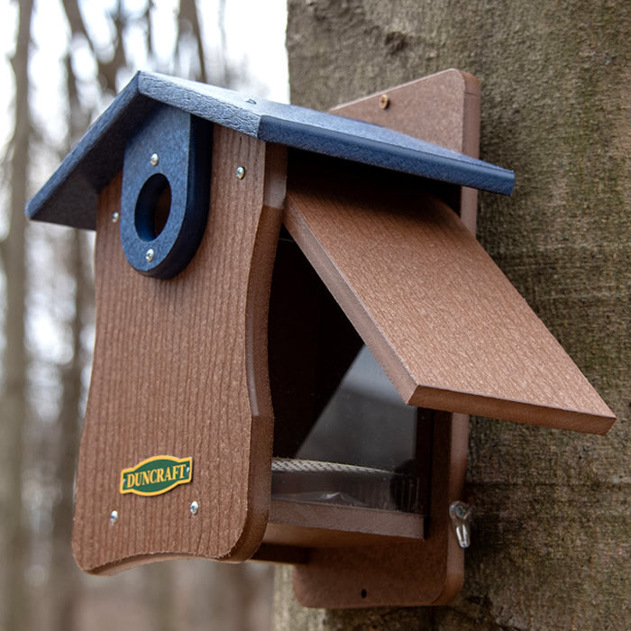 Duncraft Bird-Safe® EZ Observation Bluebird House with Predator Guard mounted on a tree, featuring side panels for easy observation and cleanout, and a 1-1/2 inch entry hole.