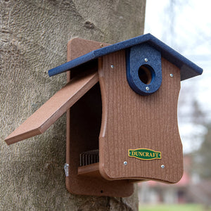 Duncraft Bird-Safe® EZ Observation Bluebird House mounted on a tree, featuring a predator guard, clearview panel, and side openings for easy observation and cleanout.