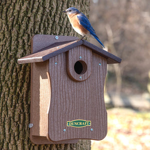 Duncraft Bird-Safe® EZ Observation Bluebird House with Predator Guard, featuring a bluebird perched on the birdhouse with visible side panels for easy cleanout and observation.