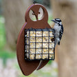 Duncraft Owl Suet Feeder with a decorative owl shape, showcasing a woodpecker clinging to the suet cage. Suitable for feeding high-energy suet to birds.