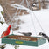 Duncraft Old Fashioned Toolbox Platform Feeder with mixed seeds, visited by a Northern Cardinal, Black-capped Chickadee, Dark-eyed Junco, and Downy Woodpecker against a snowy backdrop.