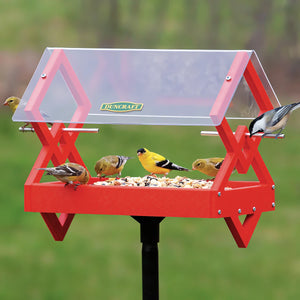 Duncraft Double Diamond Post Platform Feeder with clear roof, hosting goldfinches and chickadee, features multiple entry points and a durable red frame.