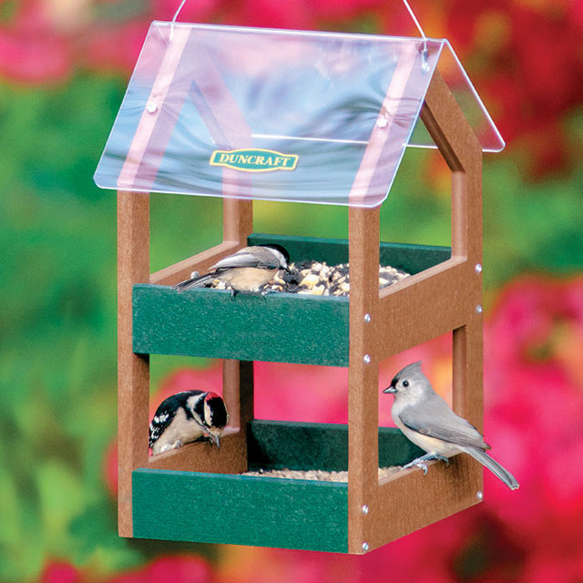 Duncraft Classic Double Decker Feeder showcasing birds feeding on two levels, with a clear plastic roof and metal mesh drainage trays.