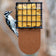 Tail Prop Suet Feeder, Brown with a Downy Woodpecker clinging, features a durable black suet cage for easy feeding and balance, holding one suet cake.