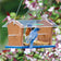 Duncraft Bluebird Central Feeder with wood panels and clear plastic roof, stocked with live mealworms, two bluebirds feeding. Features lower side walls and multiple perching spots.