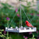 Duncraft White Picket Fence Platform Feeder with durable white recycled plastic and metal mesh drainage, showcasing a Northern Cardinal on its edge, filled with mixed seeds.