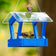 Duncraft Heritage Platform Feeder, Royal Blue, with Clearview roof. Features a mesh base, two feeding goldfinches, and a perched songbird.