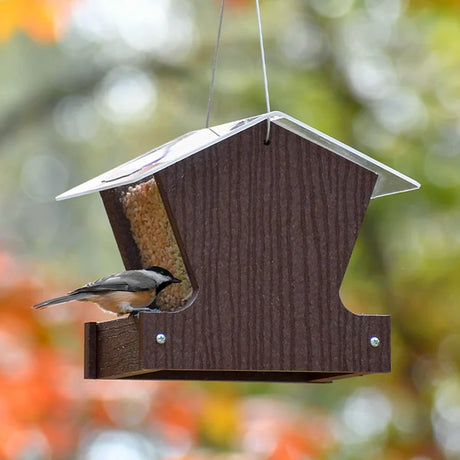 Duncraft Heritage Hopper Feeder, Milwaukee Brown, with a black-capped chickadee feeding on its ledge, showcasing eco-friendly design and seed visibility features.
