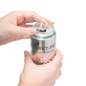 Perky-Pet® Ready-To-Use Clear Hummingbird Nectar, 16 oz., Box of 4, shown with a hand holding and opening one aluminum can of nectar.