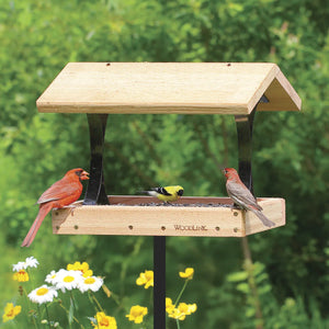 Woodlink Platform Feeder with roof, holding sunflower seeds. Features wrought-iron supports and mesh floor. Attracts various birds, including cardinal, goldfinch, and finch.