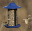 Cobalt Twin Bird Feeder with two seed compartments, blue top, and mesh hopper; a bird flies nearby, highlighting its attraction to various birds.