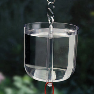 Super Big Nectar Ant Guard, a clear container filled with water, fits between your feeder and hanger to prevent ants from reaching nectar.