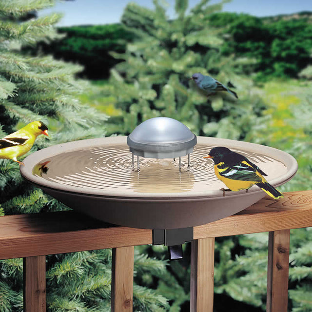 Solar Water Wiggler placed in a birdbath with birds perched on the rim, creating ripples to attract more birds and prevent mosquitoes.