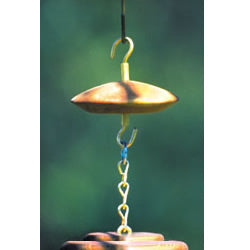 Anti-Ant Guard: Close-up of a rustic wooden disc ant moat with a deep groove filled with a sticky substance, designed to hang above hummingbird feeders.