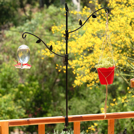 34 Deck Kit with Adjustable Branches clamped to railing, featuring a hummingbird feeder and planter, showcasing dual hooks and adjustable, decorative metal design.