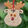 Holiday Bird Seed Cookie, Rudolph: A reindeer-shaped bird feeder made of millet and dried fruit, featuring apricot eyes, a red berry nose, and a ribbon for hanging.