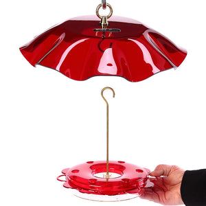 Hummerfest Feeder & Swirl Weather Guard held by a hand, showcasing the advanced dish feeder with a red cover and attached weather guard.