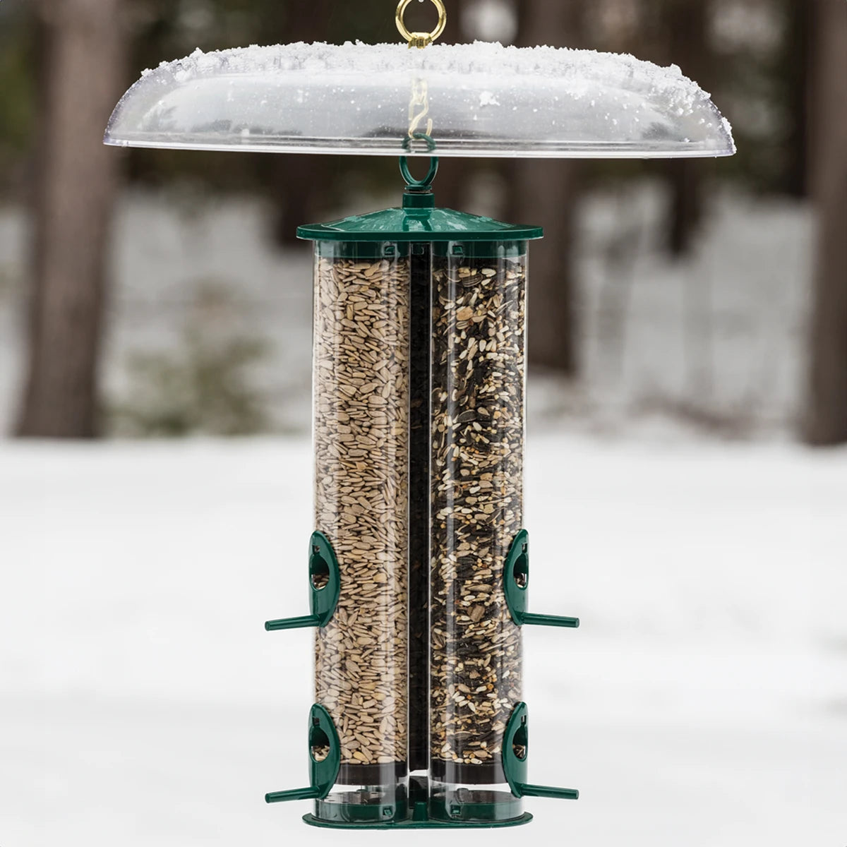 Duncraft Tilt-Top Squirrel Baffle with bird feeder filled with seeds, featuring a squirrel-proof, tilting design, and includes S-hook for hanging.