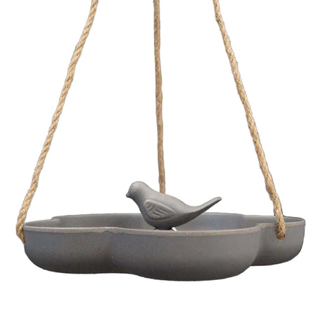 Natural Hanging Bird Bath featuring a bird perched on the feeder, showcasing its eco-friendly design made from repurposed materials, ideal for backyard use.