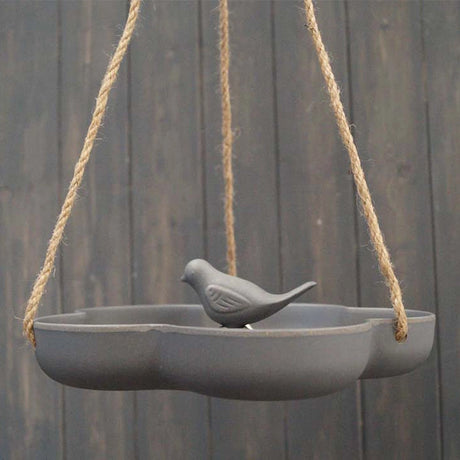 Natural Hanging Bird Bath showcasing a bird perched on its edge, highlighting its dual function as a feeder, crafted from eco-friendly materials.