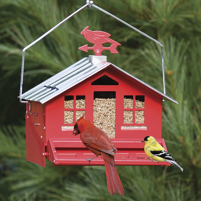 Squirrel Be Gone Country bird feeder with adjustable weight-activated perch, red birdhouse design, and two birds feeding.