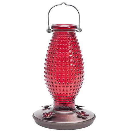 Red Hobnail Hummingbird Feeder with a metal handle, dappled glass design, and four daisy-shaped feeding ports.