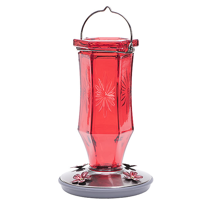 Vintage Ruby Starburst Hummingbird Feeder: Red glass feeder with embossed design, metal base, and flower-shaped feeding ports. 16 oz capacity, 8.5 inches tall.