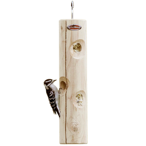 Hanging cedar suet log feeder with a downy woodpecker feeding from recessed suet holes.