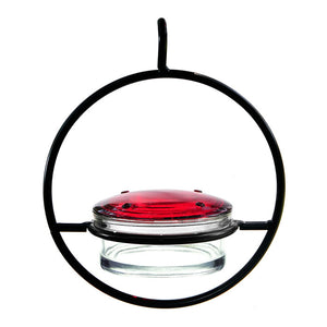 Sphere Hummingbird Feeder with a clear glass dish and handcrafted red lid, featuring four feeding ports and a durable black steel wire frame.