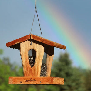 Hanging cedar hopper bird feeder with panoramic seed reservoir and protective roof.