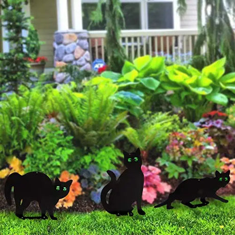 Garden Scare Cats with Reflective Eyes, Set of 4, lifelike black cat figurines in a garden setting to deter pests, featuring realistic poses and reflective eyes.
