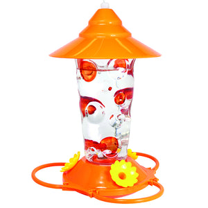 Dots Glass Oriole Feeder with a clear glass reservoir, hand-painted dots, orange top and bottom, and three flower feeding stations.